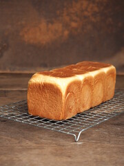 loaf of white soft bread on wooden background