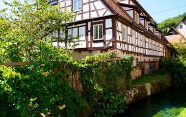 old timber-framed houses by the turquois pond called Blautopf (Blue Pot) in Blaubeuren (Germany)	
