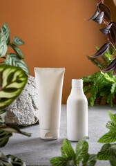 Сosmetic product branding with tropical leaves on tan color background. Cosmetic product ad with natural cosmetics ingredients for skincare and body