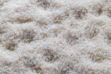 a pile of scattered white rice on the kitchen table