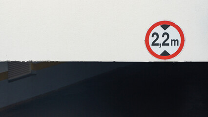 a red sign showing the height of the ceiling of 2.2 meters in the entrance to the underground...