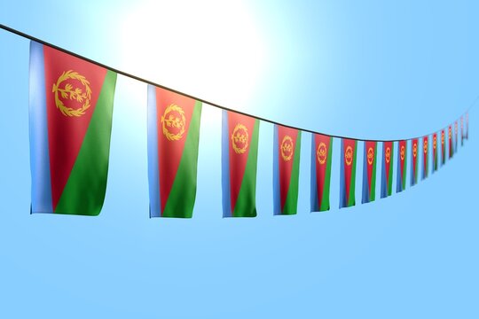 cute independence day flag 3d illustration. - many Eritrea flags or banners hangs diagonal on rope on blue sky background with soft focus