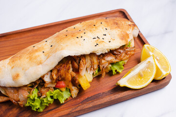 Chicken doner kebab on wooden tray top view isolated