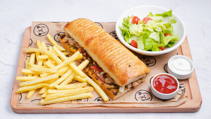 Chicken doner kebab, french fries, salad, mayonnaise and ketchup top view