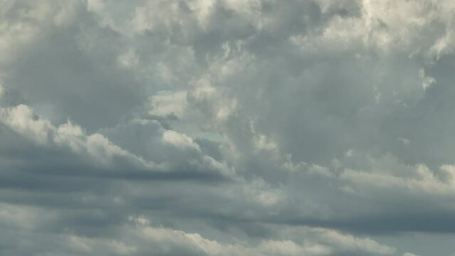 Grey clouds move slowly on overcast day