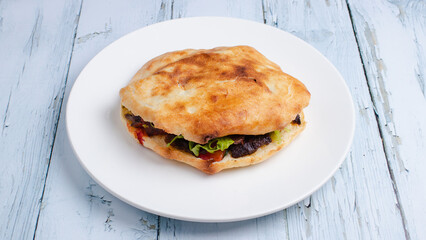 Beef tombik doner kebab in plate top view isolated