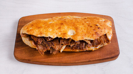 Beef doner kebab on wooden tray top view isolated