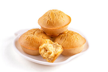 Homemade rice cupcakes with raisins on a saucer on a white isolated background. Rice flour muffins. Template for the design. The concept of proper nutrition, a gluten-free diet.