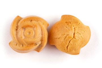 Two homemade rice cupcakes with raisins in the shape of a rose on a white isolated background. Rice flour muffins. Template for the design. The concept of proper nutrition, a gluten-free diet.