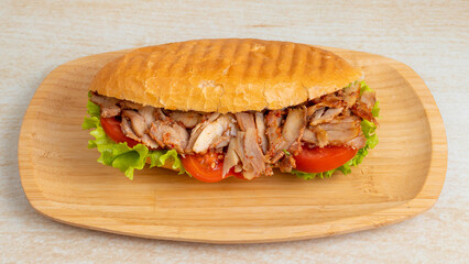 Chicken doner kebab on wooden tray top view isolated