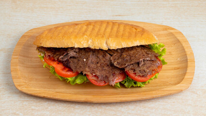 Beef doner kebab on wooden tray top view isolated