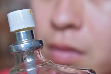 Asian, Chinese and Myanmar young man with cold flu gets loss of smell called anosmia. He smells scent of perfume.