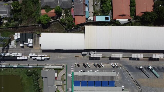 4K over Semi Trucks in the Warehouse during transportation on the leading commodity. Photo of logistic from Aerial View.