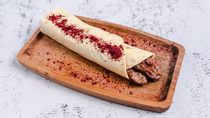 Beef durum kebab on wooden tray. Beef lavash doner kebab