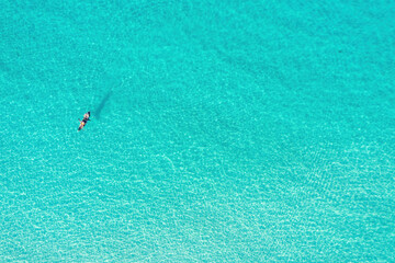 Summer vacation fun, sport activity. Men on Canoe kayak in turquoise blue Aegean Sea, aerial view.