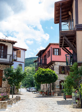 Greece, Arnaia village Chalkidiki. Mansion with loggia, tile roof, internal covered balcony, plant.