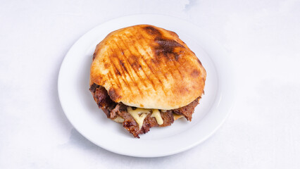 Beef tombik doner kebab in plate tray top view isolated