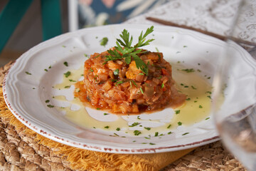 Delicious fish tartar on a white plate. Italian food concept. Ready to eat at a restaurant