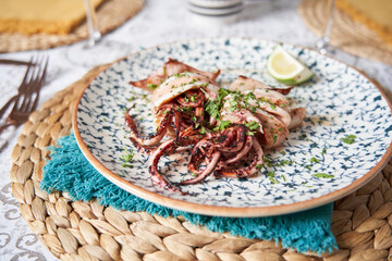 Grilled octopus with tentacles and decoration lemon in the restaurant. Food concept