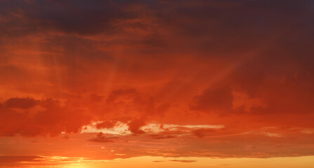 Naklejka na ściany i meble Picturesque colorful dramatic sunset illuminated by the setting sun.