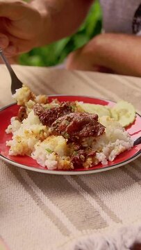 Vertical video of Eating a Popular Khmer Breakfast of  Kha sach ko or Beef Stewed in Palm Sugar