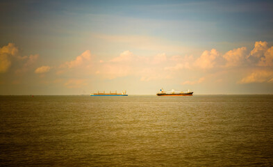 cargo ship at sunset on the sea