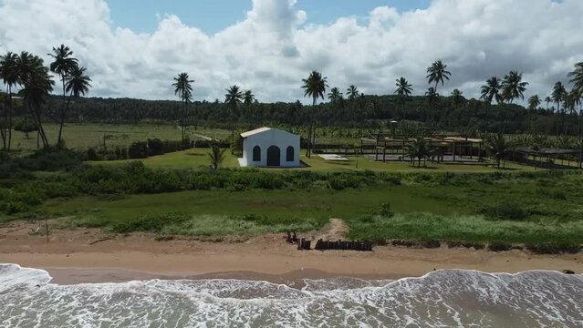 Beautiful view of Capela dos Milagres on the background of palm trees