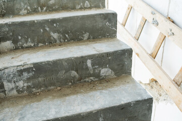 Fragment of concrete steps in a house under construction. Close-up