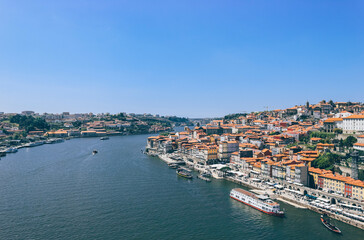 Fototapeta na wymiar View of Duoro bay of Oporto city from top with boats navigating 