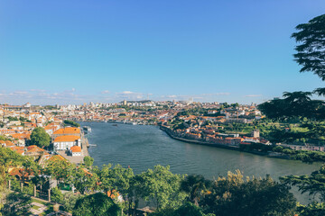 Fototapeta na wymiar River view of Porto city from green park and sun shine on houses 