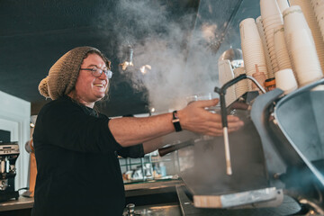 Smiling barista preparing coffee espresso in automatic coffee machine in cafe