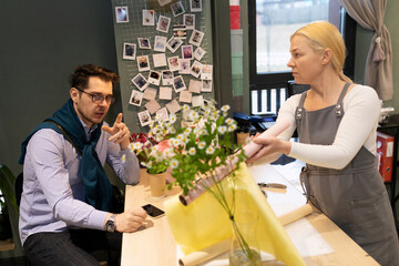 florist in the presence of the client collects a bouquet of fresh flowers