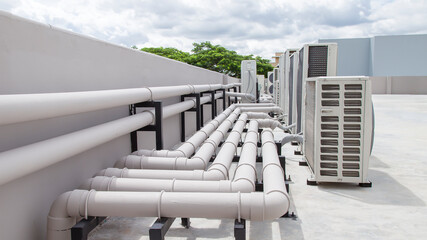 Air conditioning (HVAC) on the roof of an industrial building with blue sky.
