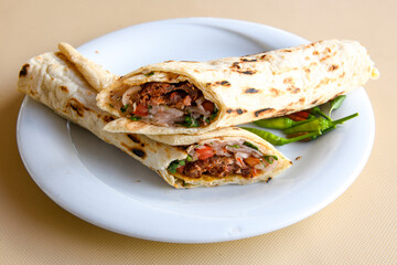 Lavash doner kebab ( zurna doner durum )  or shawarma sliced in plate isolated. 