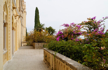 Fototapeta premium gorgeous mediterranean garden full of tropical trees and exotic pink flowers on Isola del Garda or Isola di Garda or Isola Borghese on lake Garda, Italy