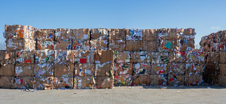 stack of old waste paper in front of recycling facility
