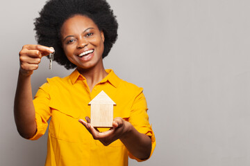 New house keys in hand of happy black woman