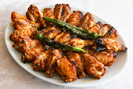 Chicken wings barbeque in a dish with BBQ grill sauce . Izgara tavuk kelebek sis kanat. Tavuk sis, gogus.