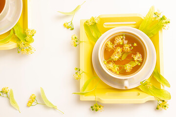 linden tea in a mother-of-pearl cup with linden flowers