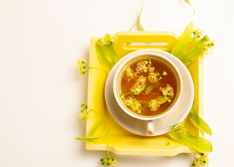 linden tea in a mother-of-pearl cup with linden flowers