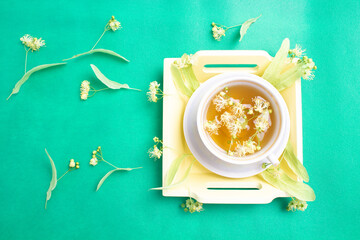 linden tea in a mother-of-pearl cup with linden flowers