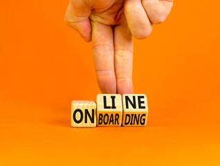 Online onboarding symbol. Concept words Online onboarding on wooden cubes. Businessman hand. Beautiful orange table orange background. Business and online onboarding concept. Copy space.