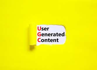 UGC user generated content symbol. Concept words UGC user generated content on white paper on a beautiful yellow background. Business and UGC user generated content concept. Copy space.