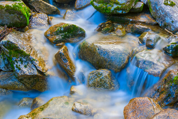 closeup river rushing in mountain forest