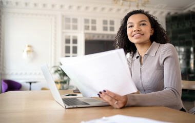 A woman in the office works with documents, responds to the client