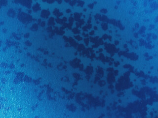 Aerial top view of blue colored sea texture with drone