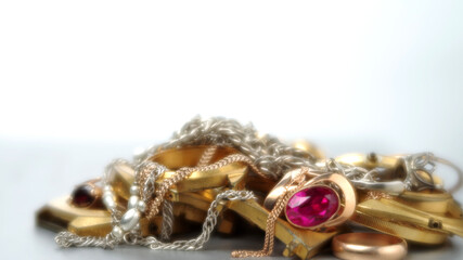 A scrap of precious metals In soft focus. Old and broken gold and silver jewelry, watches of gold...