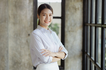 Portrait of a young beautiful Asian woman in a office room, concept image of Asian business woman, modern female executive, startup business woman, business leader woman.