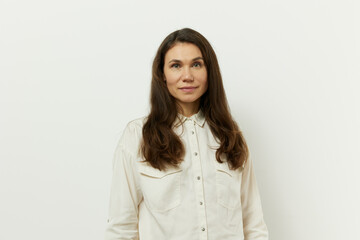 Obraz premium portrait of a beautiful happy attractive adult woman in a white shirt on a white background