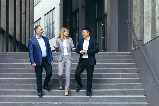 Diverse Business Team Man And Woman Walking Together On Stairs Outside Office Building, Business People Take A Walk On Break And Have Fun Talking